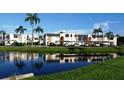 Water view and building exterior featuring beautiful landscaping and carports at 210 Fernwood Cir # 210, Seminole, FL 33777