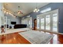 Spacious living room featuring wood floors, large windows, and neutral carpet at 22819 Southshore Dr, Land O Lakes, FL 34639