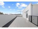Spacious rooftop deck with gray flooring, white walls, and black railings, ideal for outdoor relaxation at 307 15Th N St, St Petersburg, FL 33705