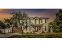 Beautiful two-story home with a well-manicured lawn, a two-car garage, and inviting front porch at 3900 W Platt St, Tampa, FL 33609