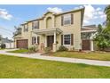 Charming two-story home with a well-manicured lawn and an inviting front porch at 3900 W Platt St, Tampa, FL 33609