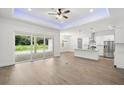 Open concept living space with wood floors and sliding glass doors to the patio at 405 Tennessee Ave, Crystal Beach, FL 34681