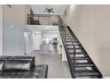 Open-concept living space features modern stairs, a loft area, a kitchen with stainless steel appliances at 4221 W Spruce St # 1407, Tampa, FL 33607