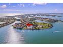 Stunning aerial view showcasing the waterfront community with lush landscaping and boat access at 530 Sandy Hook Rd, Treasure Island, FL 33706
