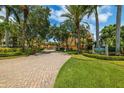 Beautiful community entrance with manicured landscaping and stately signage for Village on Venetian Bay at 530 Sandy Hook Rd, Treasure Island, FL 33706