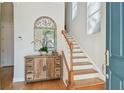 Bright foyer featuring hardwood floors, staircase, mirror and natural light at 6030 Printery St # 108, Tampa, FL 33616