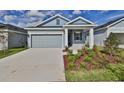 Attractive single-story home boasts a well-maintained lawn and inviting entry with beautiful plantings at 6042 Golden Nettle Dr, Apollo Beach, FL 33572