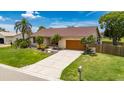 Charming one-story home featuring a well-manicured lawn, mature trees, and a convenient driveway, offering both curb appeal and functionality at 811 Eagle Ln, Apollo Beach, FL 33572