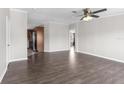 Spacious living room featuring luxury vinyl plank flooring, neutral colors and a ceiling fan at 8428 Highland Pines Ct, Plant City, FL 33565