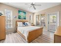 Bright bedroom featuring a ceiling fan, neutral walls, and ample natural light from the windows and door to the lanai at 10115 Courtney Palms Blvd # 202, Tampa, FL 33619