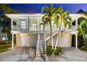 Inviting two-story home with a spacious balcony, white staircase, and a well-maintained two-car garage at 1051 Point Seaside, Crystal Beach, FL 34681