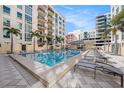 Resort style community pool with lounge chairs, cabana and beautiful tropical landscaping at 1238 E Kennedy Blvd # 704, Tampa, FL 33602