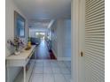 Bright and airy foyer with tile floors, leading to the main living spaces with hardwood flooring and view of intercostal waterway at 131 Bluff View Dr # 208, Belleair Bluffs, FL 33770