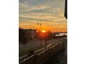 Breathtaking sunset view over the water from this charming residence with palm trees and street at 131 Bluff View Dr # 208, Belleair Bluffs, FL 33770