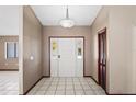 Bright foyer with white tile floors and a front door with sidelights at 13112 Groveland St, Spring Hill, FL 34609