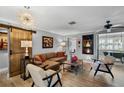 A stylish living room featuring a sliding barn door, modern light fixture, and a cozy fireplace at 1350 Maple Sw St, Largo, FL 33770