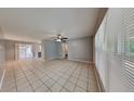 Spacious living area featuring neutral paint, large windows, and tile flooring throughout at 18236 Ackerman Ave, Port Charlotte, FL 33948