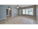 Bright living room featuring neutral paint, tile flooring, and ample natural light at 18236 Ackerman Ave, Port Charlotte, FL 33948
