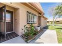 Inviting front entrance with a glass storm door and lovely landscaping with a stone border at 19029 Us Highway 19 N # 30H, Clearwater, FL 33764