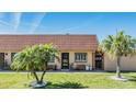 Delightful villa boasting a terra-cotta-colored roof, well-kept lawn and tropical palm trees at 19029 Us Highway 19 N # 30H, Clearwater, FL 33764