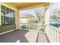 Relaxing front porch with white picket fence, providing an inviting outdoor space for enjoying the neighborhood view at 20326 Merry Oak Ave, Tampa, FL 33647