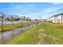 Townhome backyard featuring a waterway view, green lawn, and white fencing at 2109 Laceflower Dr, Brandon, FL 33510