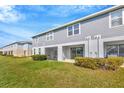 Exterior view of a two-story home with sliding glass doors leading to a screened-in porch at 2109 Laceflower Dr, Brandon, FL 33510