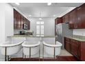 Eat-in kitchen with stainless steel appliances, granite countertops, and breakfast bar at 2240 Soho Bay Ct, Tampa, FL 33606