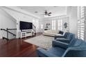 Bright living room featuring dark wood floors, tray ceilings, and plantation shutters at 2240 Soho Bay Ct, Tampa, FL 33606