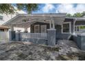 Charming single-story home featuring a covered front porch with classic white trim and gray accents at 2921 W El Prado Blvd, Tampa, FL 33629