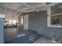 Inviting front porch featuring a porch swing, white pillars, and gray accents at 2921 W El Prado Blvd, Tampa, FL 33629