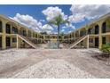 Inviting courtyard with a centrally located pool and multiple stairwells accessing upper-level units at 3206 W Azeele St # 129, Tampa, FL 33609