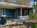 Exterior view of the home showing screened in porch, carport, and green painted siding at 4501 27Th S Ave, Gulfport, FL 33711