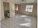 Living room featuring white tile floors, and two windows providing natural light at 4501 27Th S Ave, Gulfport, FL 33711