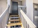 Staircase leading to unit entrance with painted door and modern hardware at 4928 W Gandy Blvd # G203, Tampa, FL 33611