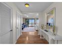 Inviting foyer featuring hardwood floors, a console table with decor, and a glimpse of the water view at 5010 Bayshore Blvd # 9, Tampa, FL 33611
