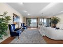 Bright living room showcasing hardwood floors, balcony access, and stylish blue and white accents at 5010 Bayshore Blvd # 9, Tampa, FL 33611
