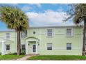 Exterior view of a two-story condo building with white trim and a well-kept lawn at 5231 Beach Se Dr # A, St Petersburg, FL 33705
