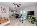 A cozy living room features tile floors, a ceiling fan, and access to the outdoor patio at 5231 Beach Se Dr # A, St Petersburg, FL 33705