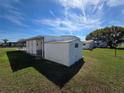 Shows the home's exterior, including a storage shed and well-maintained lawn at 5403 Comanche St, Zephyrhills, FL 33542