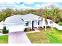 Beautiful single-story home boasts a manicured lawn, brick driveway, and modern design elements at 809 30Th E Ct, Bradenton, FL 34208
