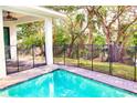Inviting pool area is surrounded by a secure fence and lush greenery, ensuring privacy at 809 30Th E Ct, Bradenton, FL 34208