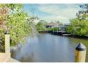Picturesque waterfront view featuring calm waters and a private dock with a gazebo and lush greenery at 809 30Th E Ct, Bradenton, FL 34208