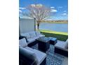 Relaxing patio with plush outdoor furniture and a serene lake view at 9208 Hillcroft Dr, Riverview, FL 33578