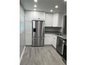Updated kitchen featuring granite countertops, stainless steel appliances, and ample storage at 10351 Regal Dr # 10, Largo, FL 33774