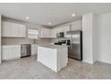 Bright kitchen featuring stainless steel appliances and a center island with counter seating at 10352 Cross River Trl, Parrish, FL 34219