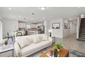 Open-concept living room and kitchen featuring stainless steel appliances and modern furnishings at 10352 Cross River Trl, Parrish, FL 34219