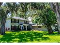 Charming two-story home with well-manicured lawn, mature landscaping, and attached garage at 1857 Castle Woods Dr, Clearwater, FL 33759