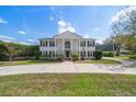 Stately two-story home with black shutters, white columns, and a circular driveway at 2102 S Fore Cir, Tampa, FL 33612