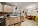 Kitchen with light wood cabinets, stainless appliances, and a cozy breakfast nook area at 2102 S Fore Cir, Tampa, FL 33612